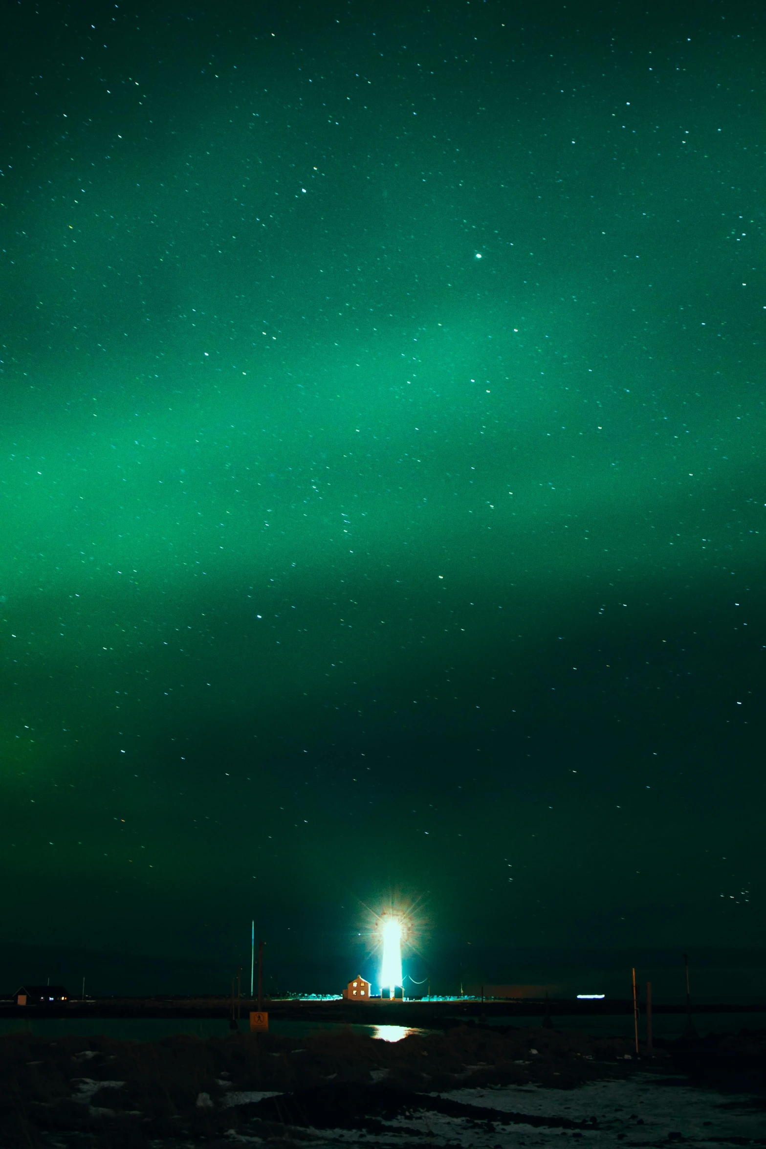 an auroral light shines in the sky over a body of water, by Anato Finnstark, lighthouse, high quality image