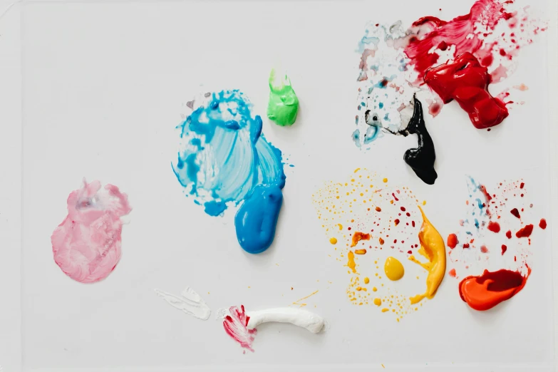 a close up of paint on a white surface, inspired by Shōzō Shimamoto, trending on pexels, toothpaste blast, children's artwork, various colors, studio shot