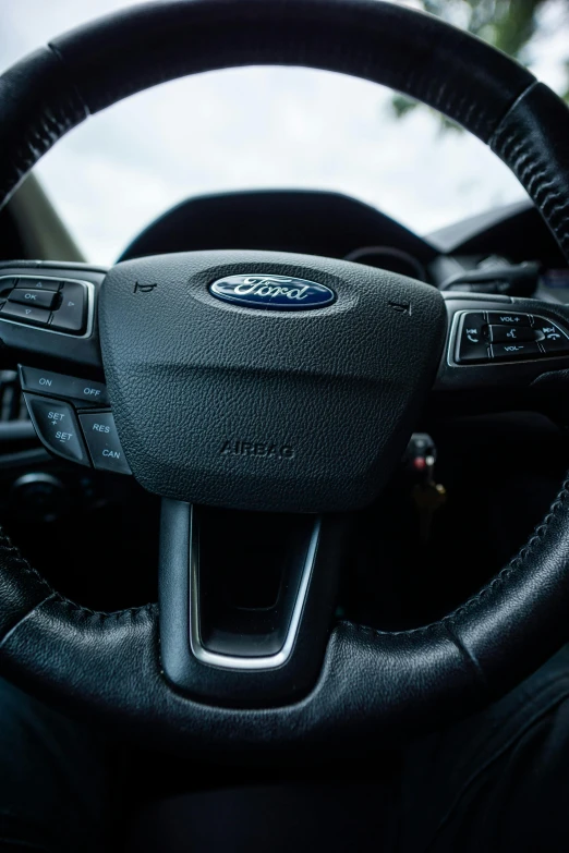 a close up of a steering wheel on a car, ford, ultradetail face, square, high-quality photo