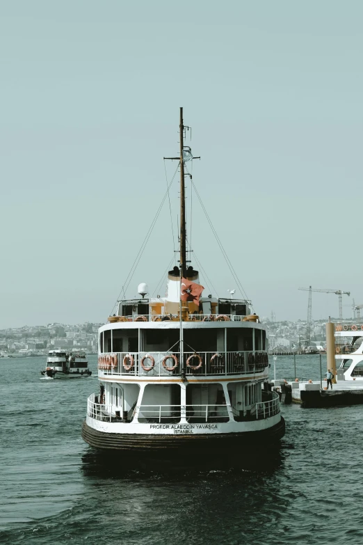 a large boat floating on top of a body of water, by Carey Morris, pexels contest winner, art nouveau, fallout style istanbul, white, scandinavian, slide show