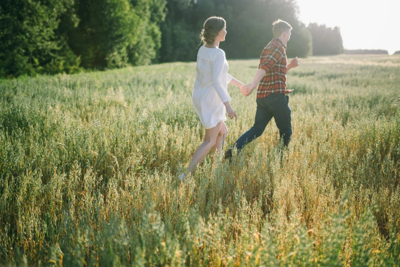 a couple running through a field of tall grass, by Jessie Algie, pexels, beautifully soft lit, soft shade, spring evening, single