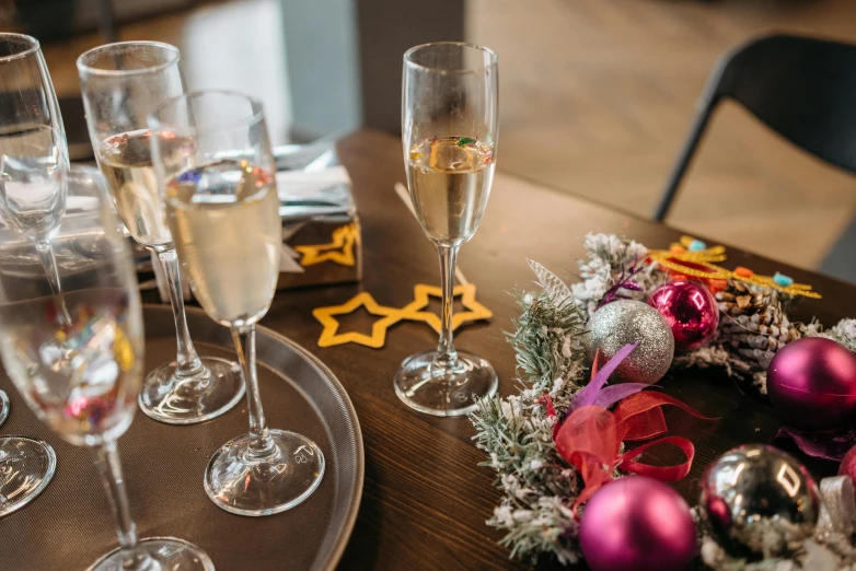 a bunch of wine glasses sitting on top of a table, pexels, decorated ornaments, casually dressed, bubbly, pair of keycards on table