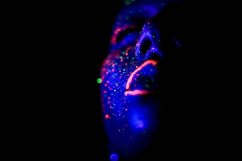 a close up of a person's face in the dark, by Jan Rustem, pexels, pointillism, uv blacklight, jelly glow, !!! colored photography, blob
