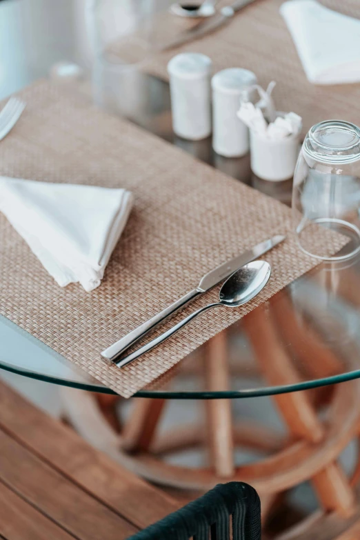 a glass table with a place setting on it, pexels contest winner, sustainable materials, spoon placed, closeup - view, cuban setting