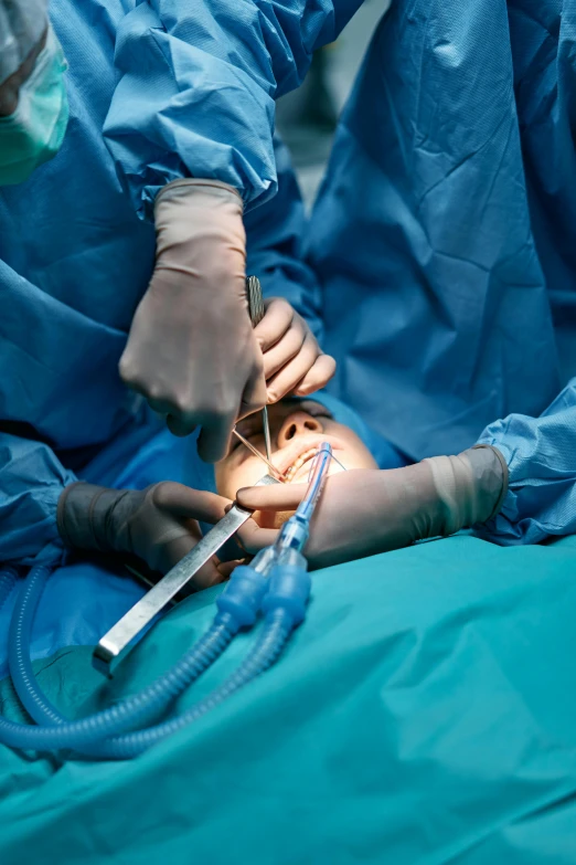 a group of surgeons performing surgery on a patient, an album cover, by Adam Marczyński, shutterstock, tight shot, high quality picture, small in size, surgical supplies