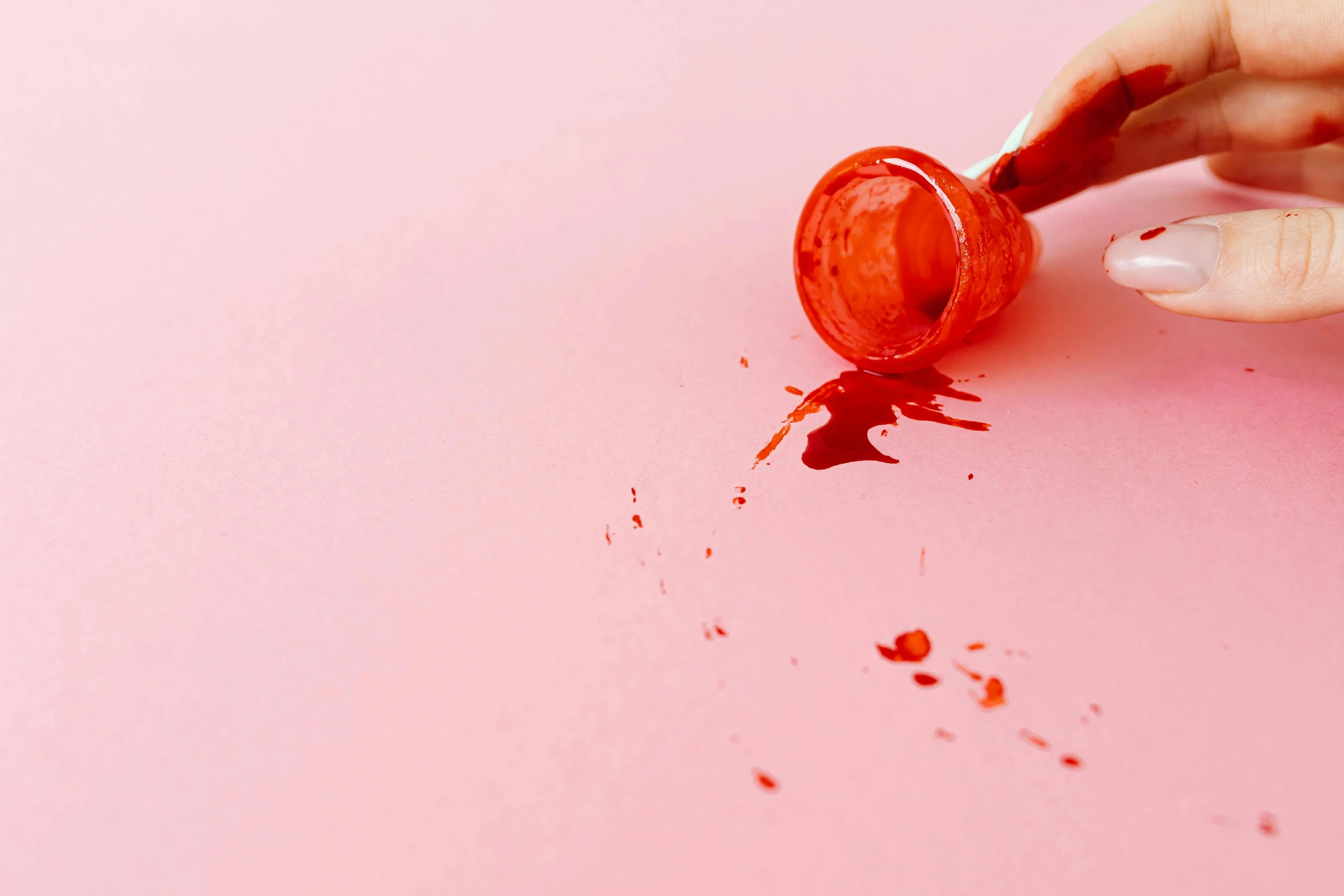 a woman's hand sprinkles red paint onto a pink surface, trending on pexels, puking blood, rubber stamp, murder scene, amanda lilleston