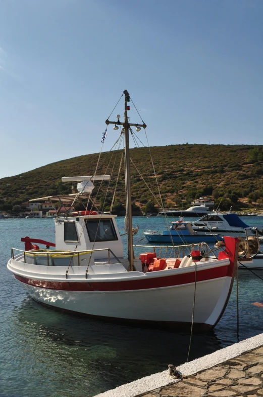 a boat that is sitting in the water, hydra, red and white, square, fish seafood markets