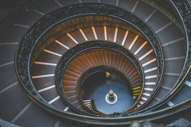 a spiral staircase in the middle of a building, inspired by Michelangelo Buonarotti, unsplash contest winner, neoclassicism, flashing lights, roman numerals, bronze, thumbnail