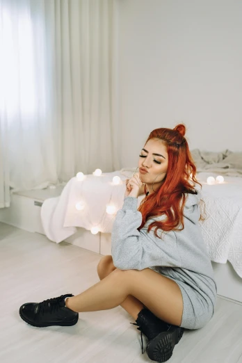 a woman sitting on the floor in front of a bed, trending on pexels, bright red hair, ruan cute vtuber, lights, gif