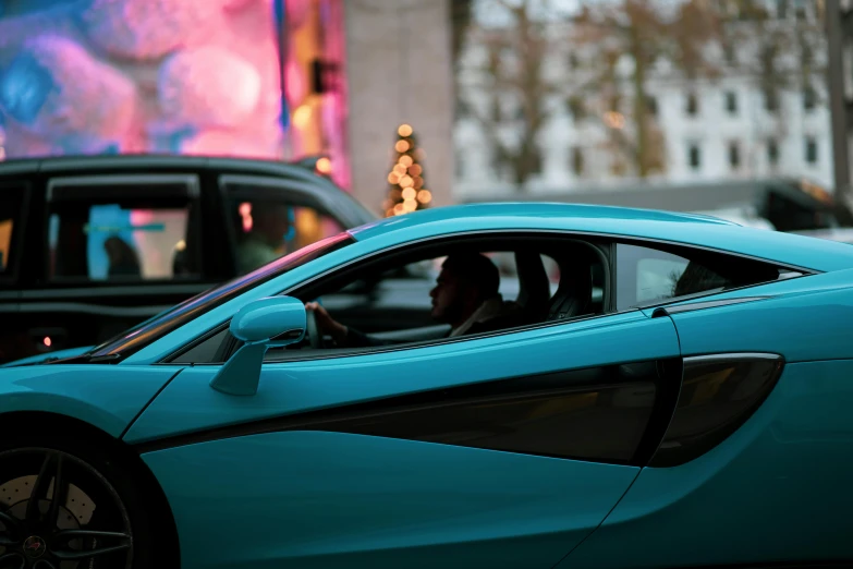 a blue sports car driving down a city street, by Sebastian Vrancx, pexels contest winner, renaissance, festive, veneno, contemplating, inside of a car