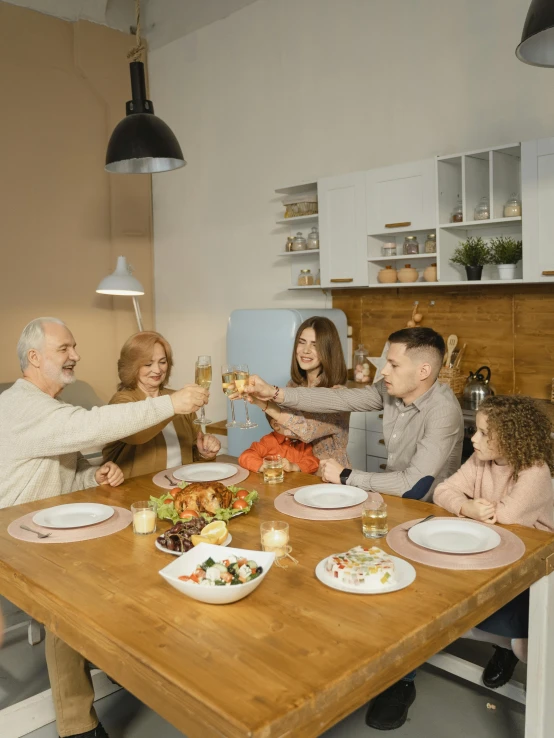 a group of people sitting around a wooden table, a picture, kitchen table, caring fatherly wide forehead, profile image, cheers