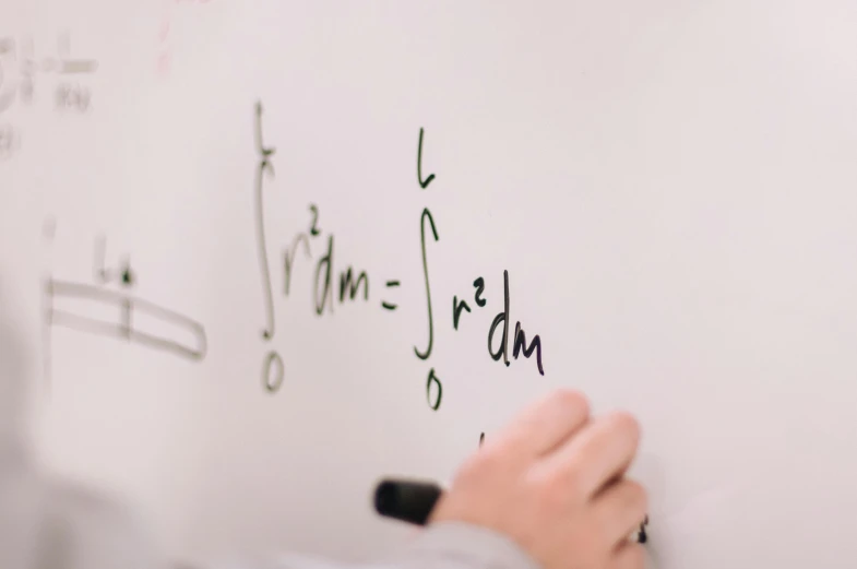 a person writing on a white board with a marker, by Carey Morris, pexels, equations, magical notes, liam brazier, middle shot
