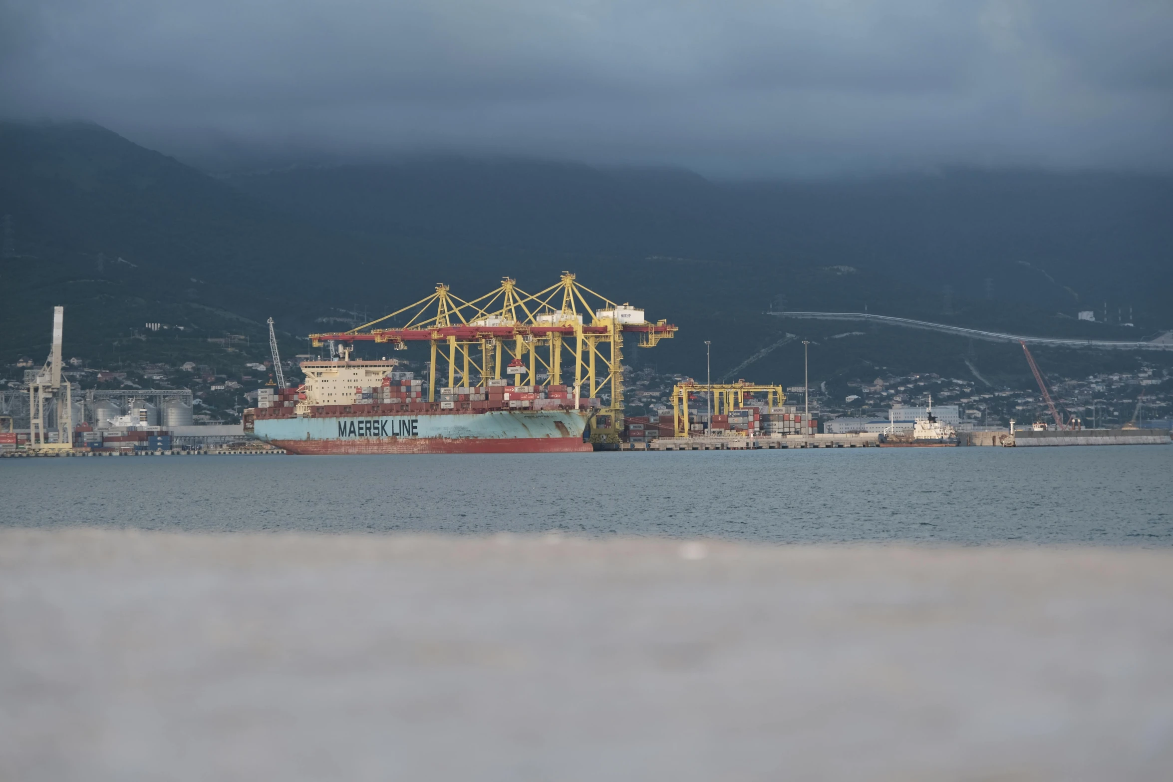 a large cargo ship sitting on top of a body of water, wellington, avatar image, cinematic image