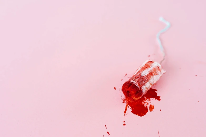 a close up of a toothbrush on a pink surface, an album cover, pexels, visual art, bloody scene, candy treatments, stab wound, red and white color theme