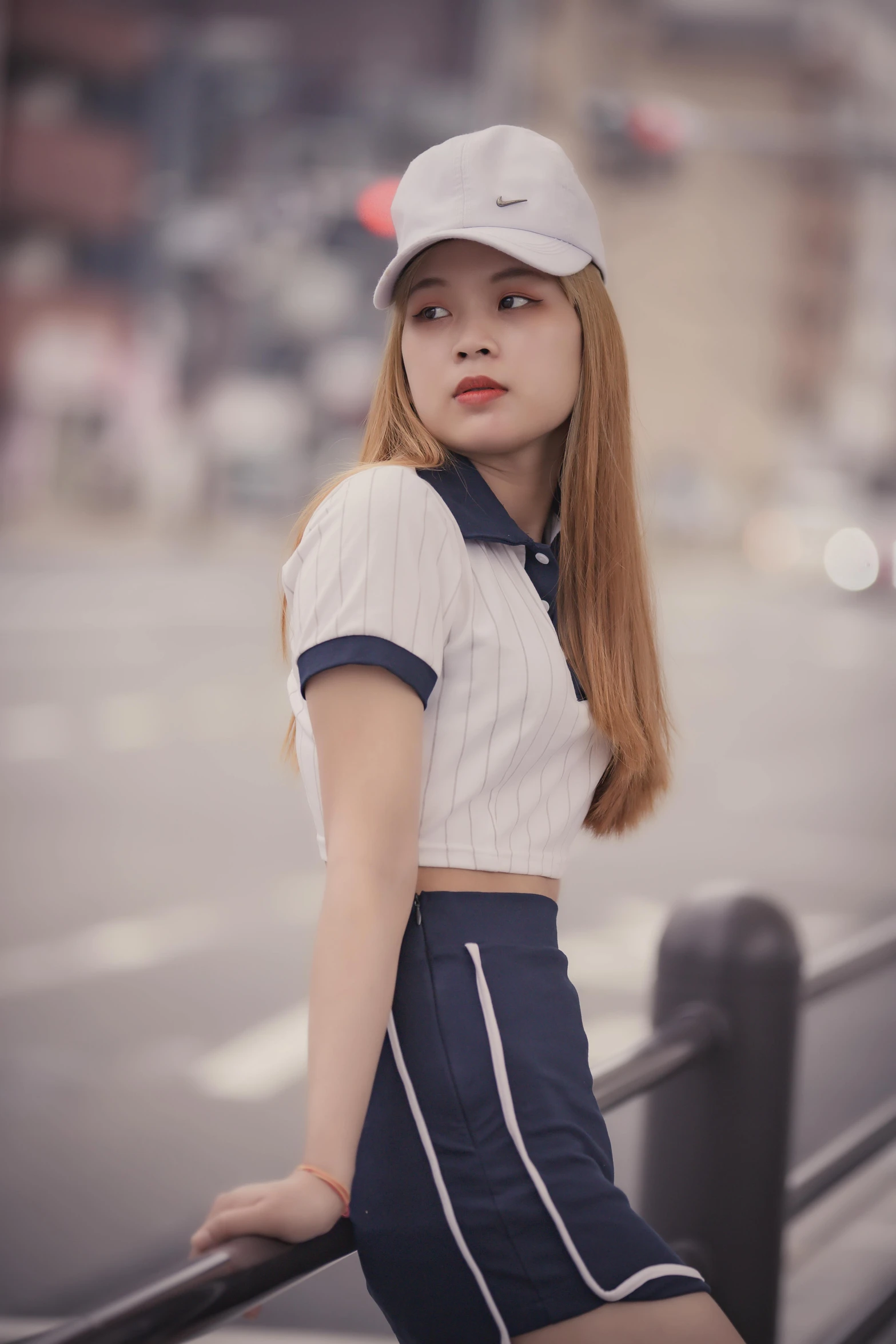 a beautiful young woman standing next to a railing, an album cover, inspired by Kim Jeong-hui, unsplash, realism, wearing polo shirt, wearing baseball cap, 🤤 girl portrait, ulzzang