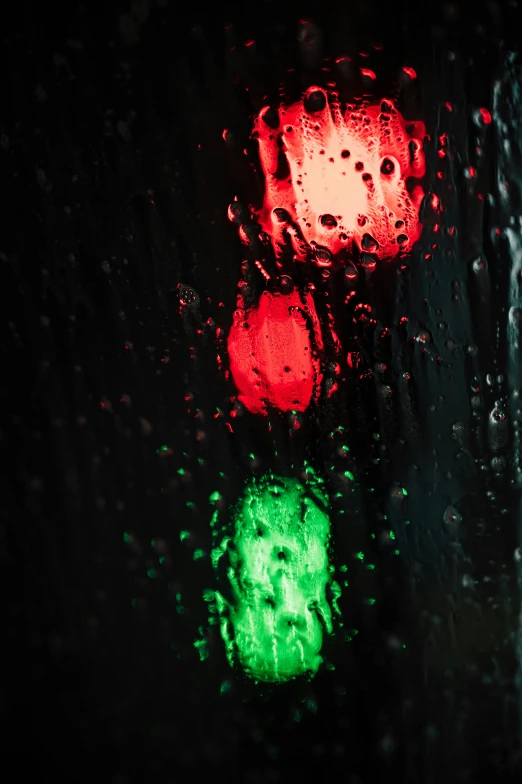 a close up of a traffic light on a rainy day, an album cover, by David Donaldson, paul barson, red and green hour, concerned, nighttime