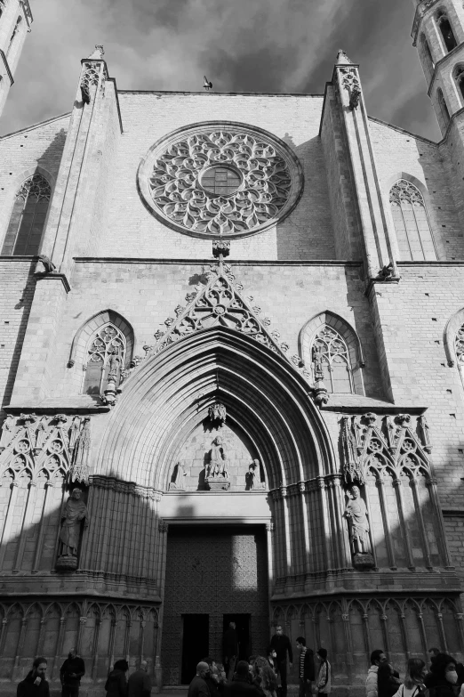 a black and white photo of a church, inspired by Barthélemy d'Eyck, romanesque, teruel city in 1989, stone facade, cathedral of sun, a middle-shot from front