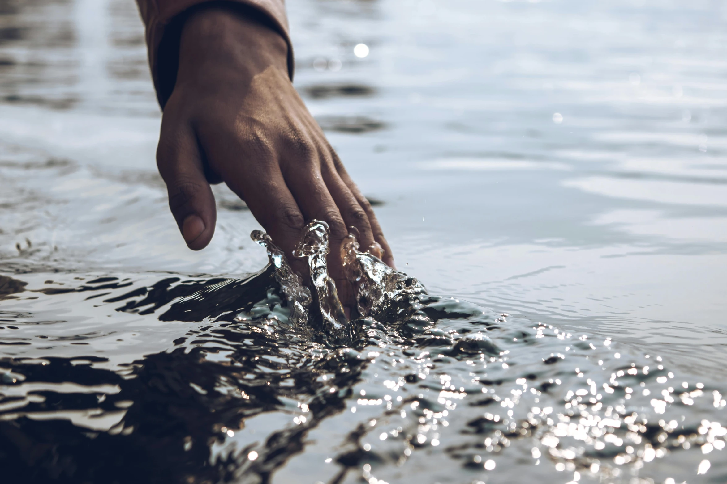 a person touching the surface of a body of water, hydration, grey, detailing, high quality product image”