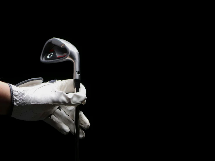 a close up of a person holding a golf club, by Matthias Stom, photorealism, white gloves, dramatic product lighting, rectangle, technology