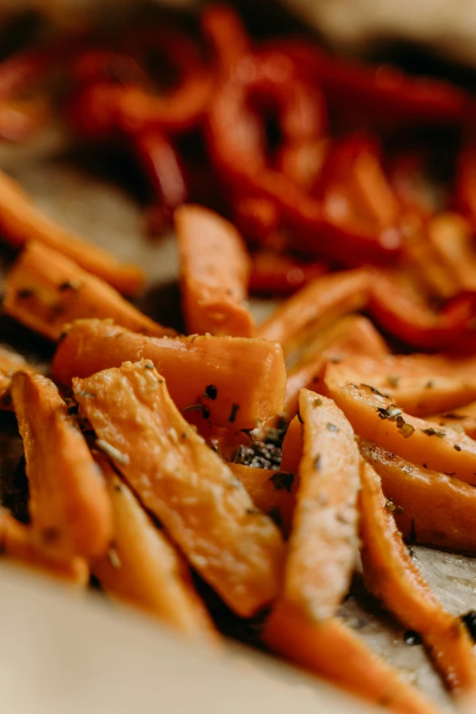 a pile of cut up carrots sitting on top of a table, by Carey Morris, pexels, serving fries, pepper, thumbnail, background image