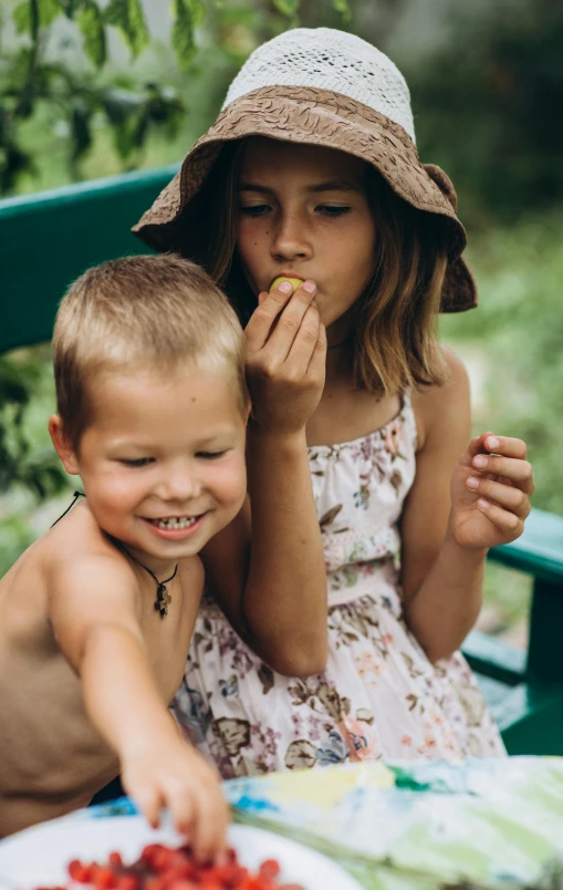 two children sitting on a bench eating strawberries, a picture, pexels, flower child, portrait image, manuka, digital image