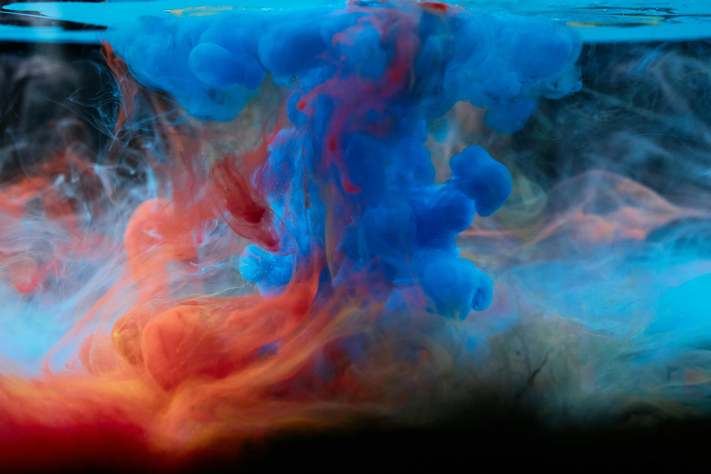 a blue and red liquid is in the water, a painting, inspired by Kim Keever, unsplash contest winner, colored ink, cloud of smoke, taken in 2022, a dark underwater scene