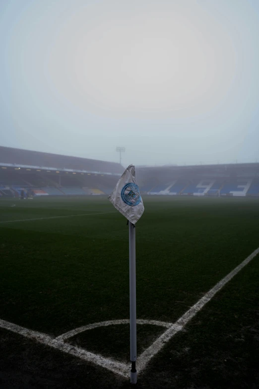 a soccer field on a foggy day, a picture, reddit, blue and white, covered in ice, chesterfield, low quality photo