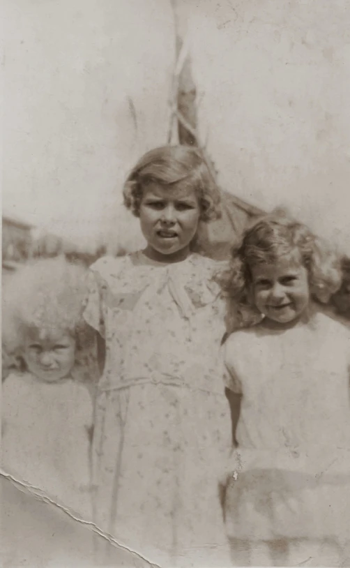 a couple of little girls standing next to each other, a black and white photo, taylor swift as a boy, digital image, three women, historical footage