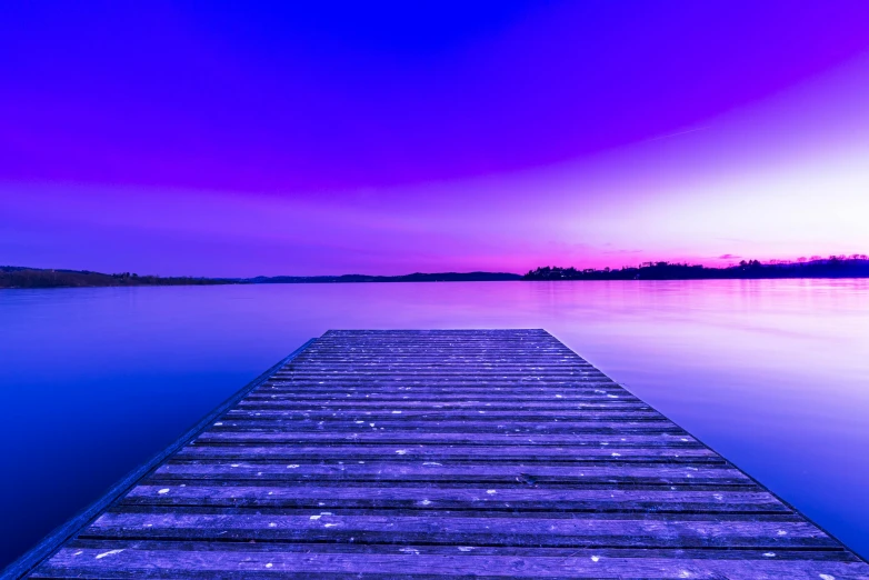 a dock sitting on top of a body of water, an album cover, unsplash, blue and purple colour scheme, serene evening atmosphere, vibrant colour, at peace