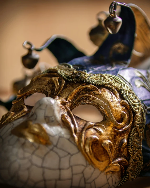 a close up of a mask on a table, trending on pexels, renaissance, thumbnail, ornately dressed, in the center of the image, lgbtq