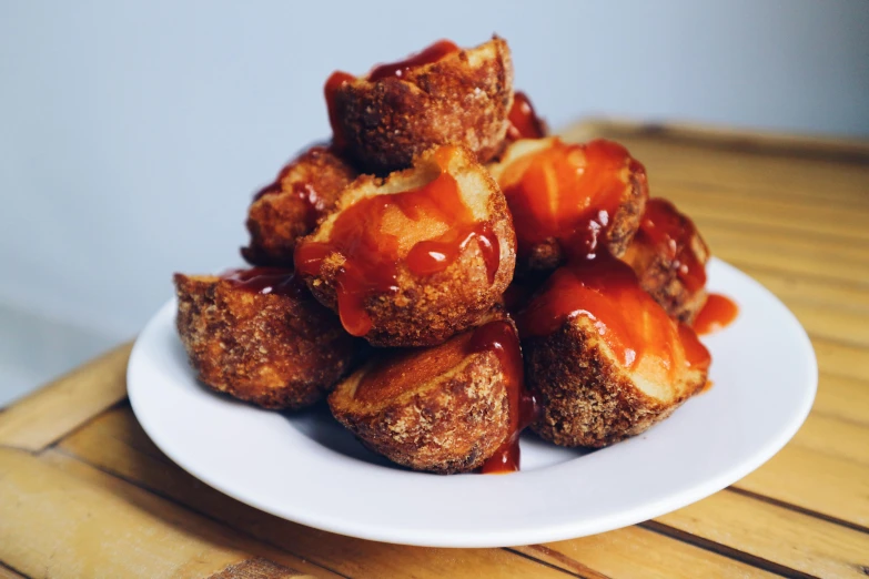 a white plate topped with donuts covered in ketchup, unsplash, dau-al-set, jajaboonords flipjimtots, stacked, bowl, profile image