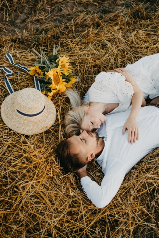 a man and woman laying on top of a pile of hay, pexels contest winner, romanticism, midsommar style, flatlay, white, profile pic