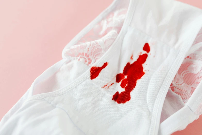 a pair of underwear with blood on it, by Julia Pishtar, trending on pexels, superfine ink detail, vandalism, with a white, product shot