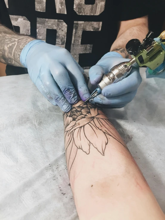a man getting a tattoo on his arm, a tattoo, by Meredith Dillman, pexels contest winner, process art, flower power, black outlines, snapchat photo, ilustration