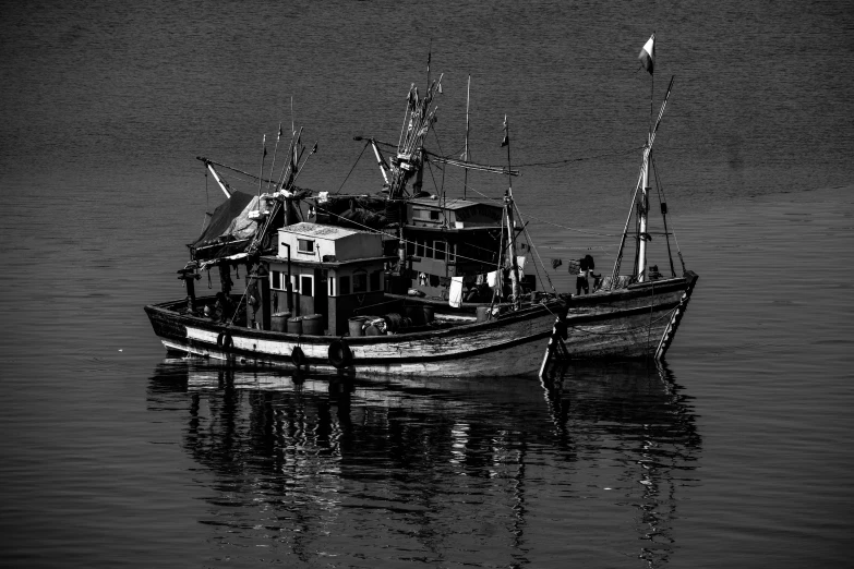 a black and white photo of a boat in the water, a black and white photo, by Jim Nelson, pixabay, precisionism, two male, fishing boats, complex and intricate, deep colour