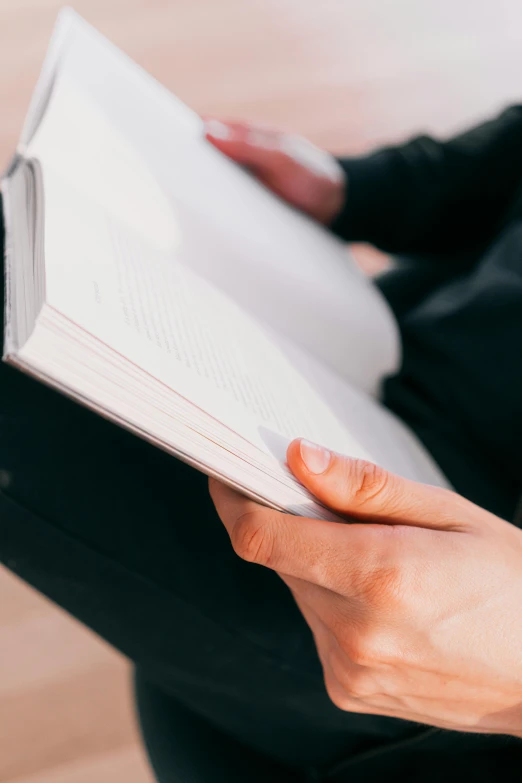 a woman sitting on the floor reading a book, by Carey Morris, trending on unsplash, detail shot, he is holding a large book, blank, ilustration