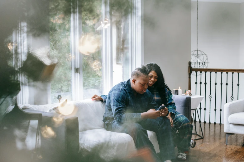 a man and woman sitting on a couch in a living room, pexels contest winner, hug, checking her phone, natasha tan maciej kuciara, elves sitting on the couch