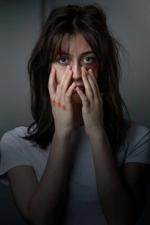 a woman covers her face with her hands, antipodeans, with a bruised face and bruises, curtain bangs, square, profile image