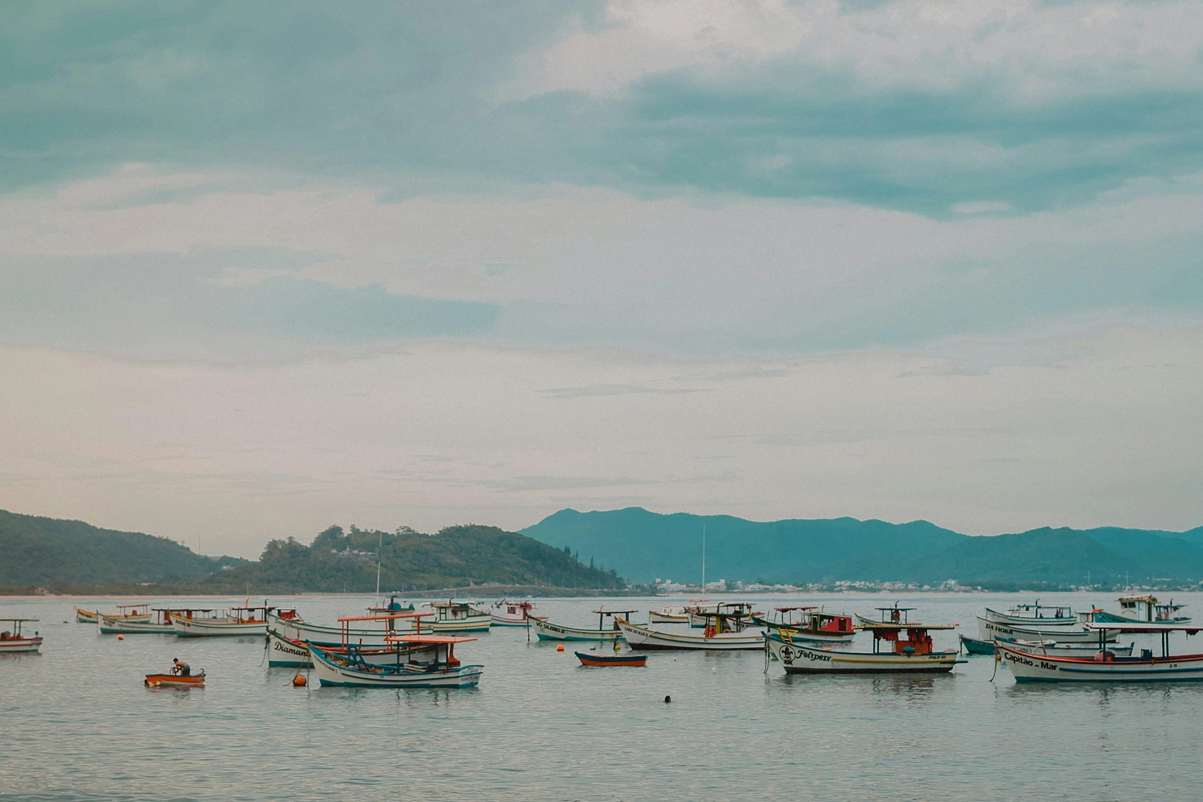 a group of boats floating on top of a body of water, by Elsa Bleda, unsplash contest winner, fishing village, oscar niemeyer, profile image, panoramic view