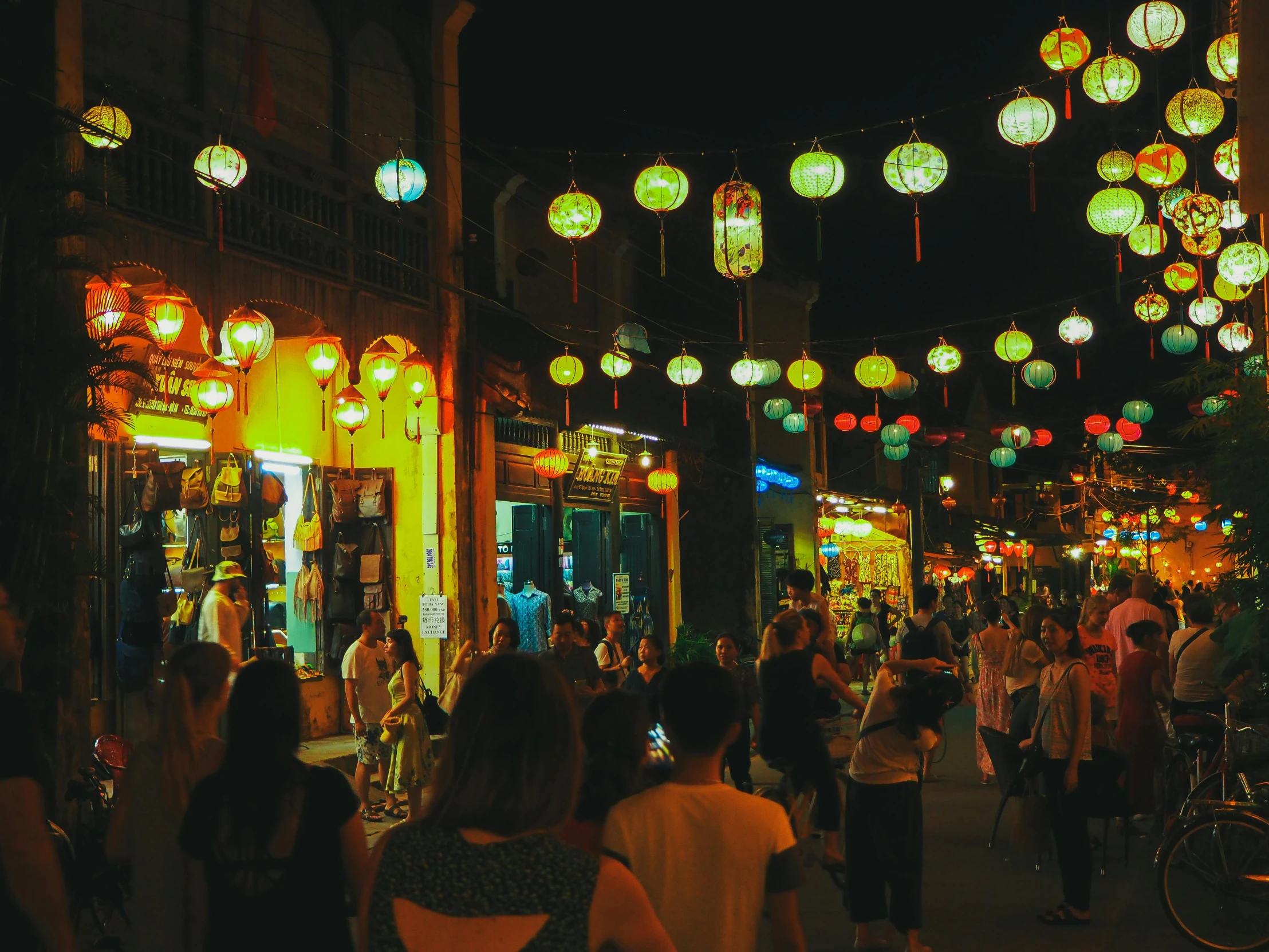 a group of people walking down a street at night, colorful lanterns, green alleys, fan favorite, nightlife