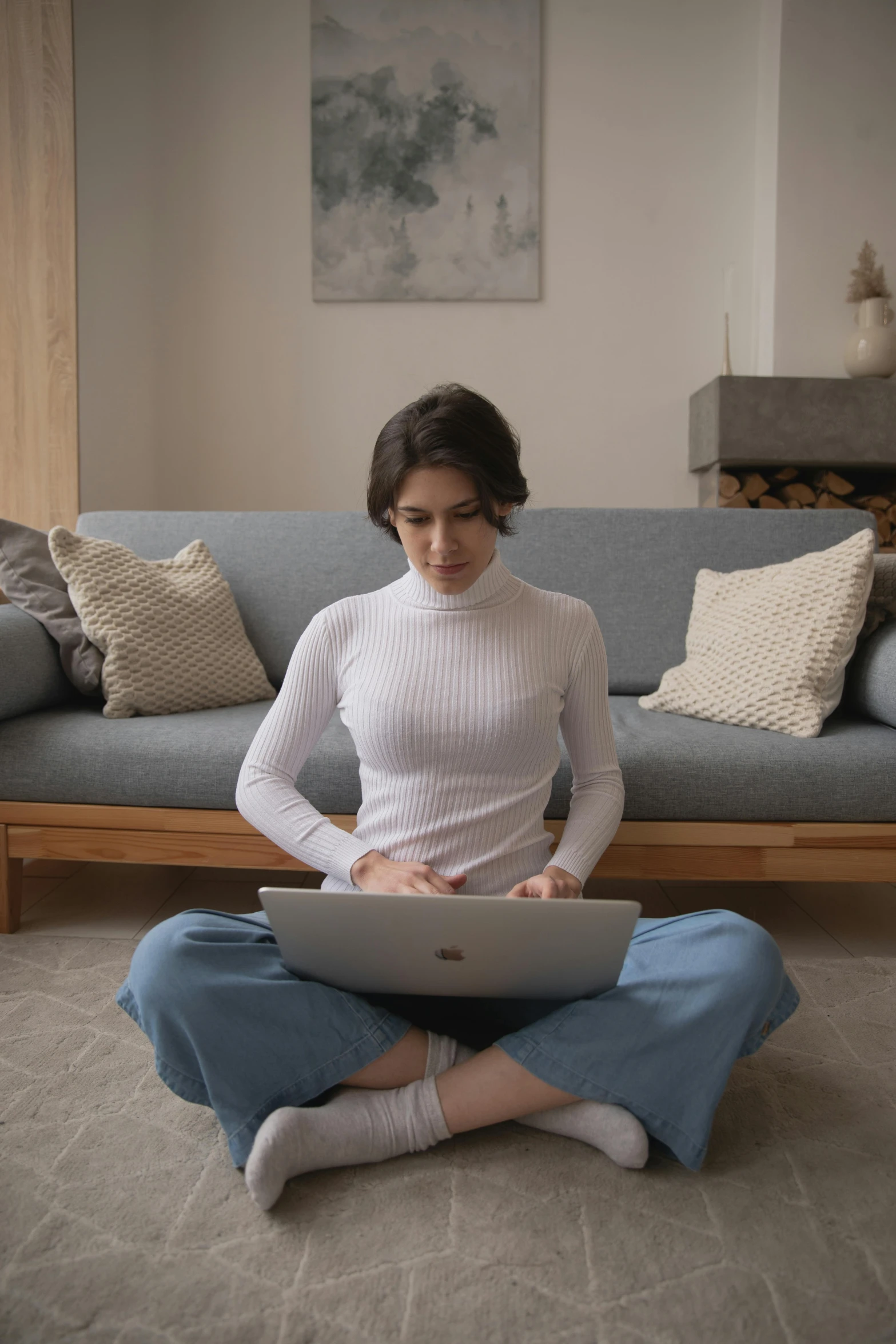 a woman sitting on the floor using a laptop, inspired by Li Di, pexels contest winner, renaissance, in white turtleneck shirt, couch, centered full body, reddit moderator