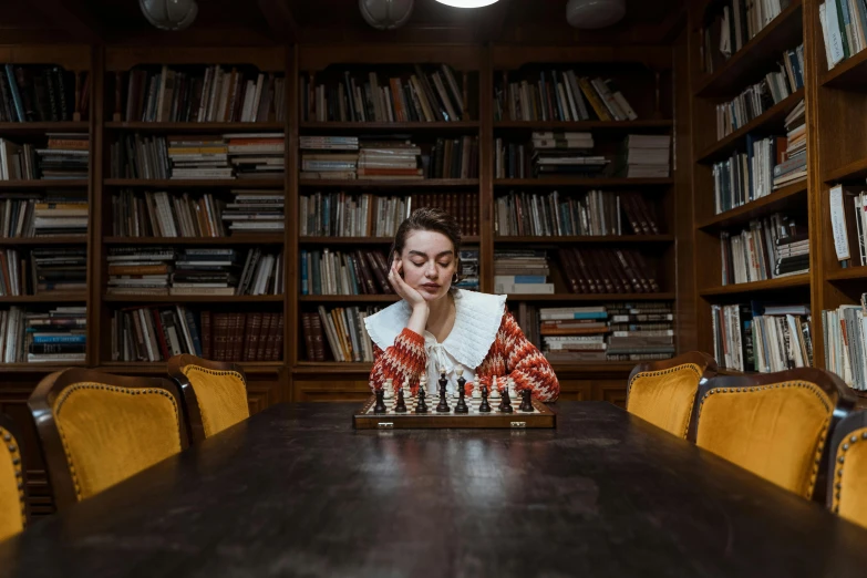 a woman sitting at a table with a chess board in front of her, by Emma Andijewska, unsplash contest winner, mannerism, in a library, 15081959 21121991 01012000 4k, thumbnail, russian academic