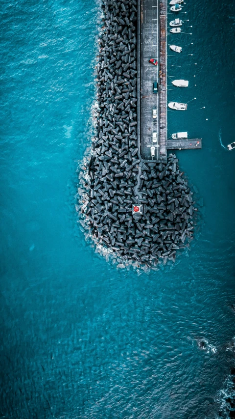 a group of boats floating on top of a body of water, by Ibrahim Kodra, unsplash contest winner, an island made of caviar, black and cyan color scheme, square, crowd