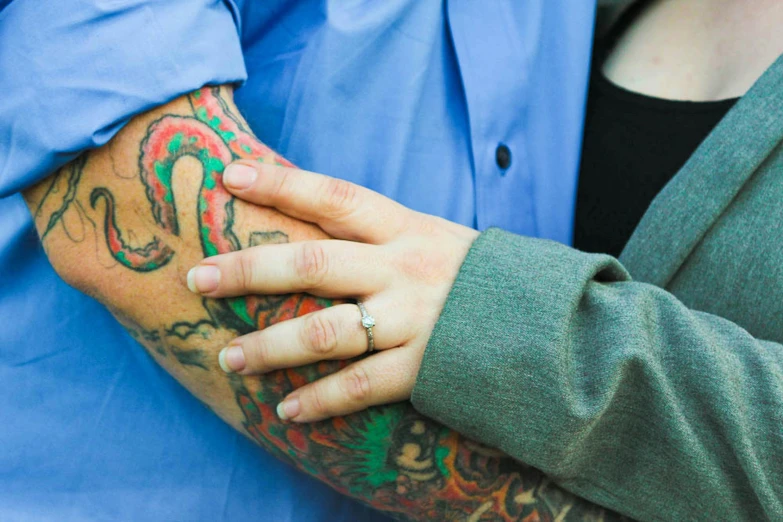 a close up of a person with a tattoo on their arm, a tattoo, by Meredith Dillman, couple, coloured photo, engaging, tattoo parlor photo