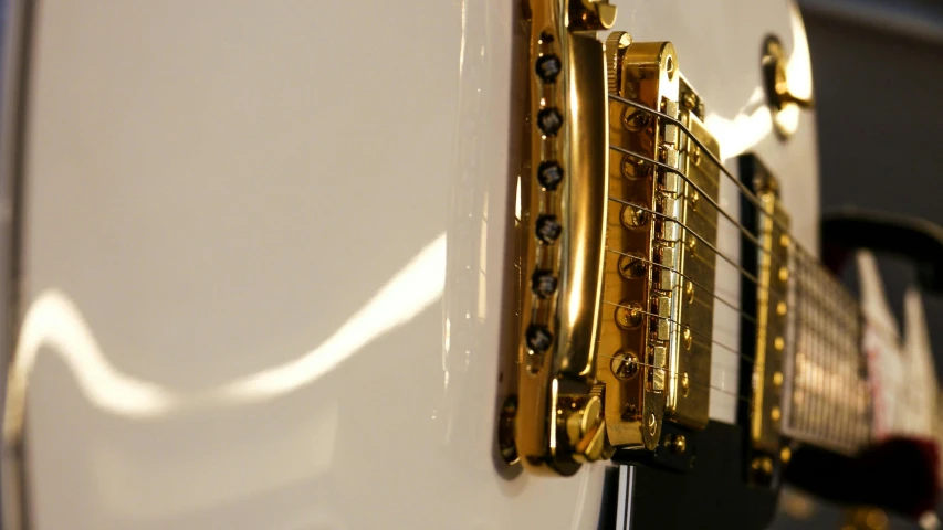 a close up of a white electric guitar, by David Simpson, arabesque, shiny gold, shoulder level shot, superior, strings