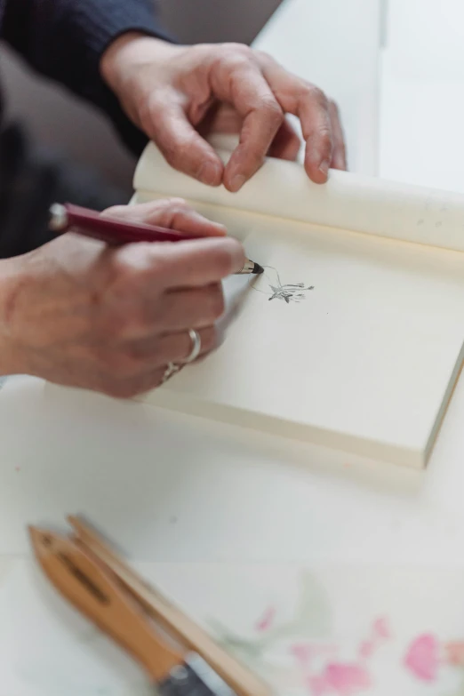 a close up of a person writing on a piece of paper, a drawing, detailed book illustration, with a white background, bespoke, explosion drawing