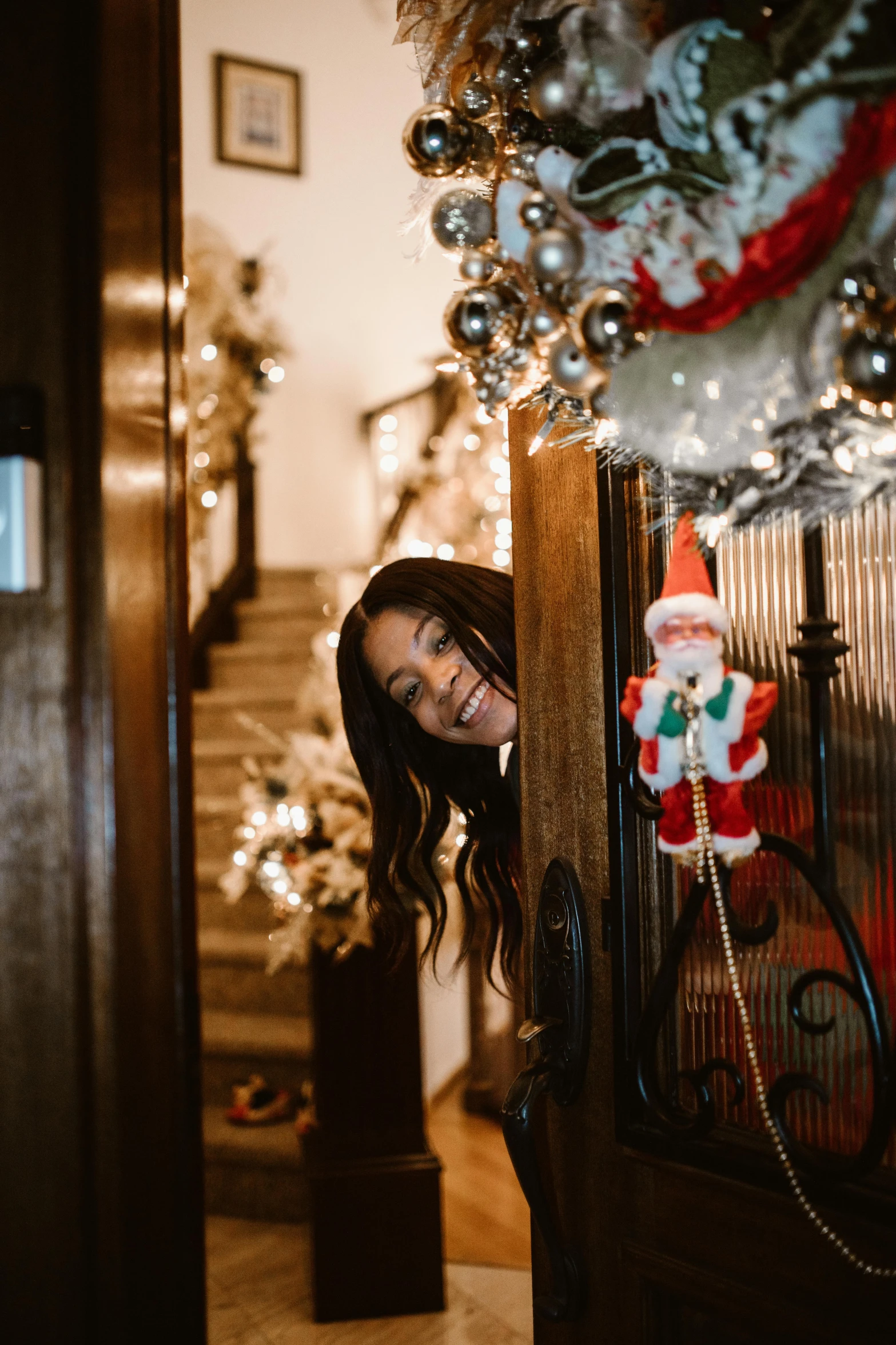 a woman standing in front of a christmas tree, pexels contest winner, happening, about to enter doorframe, smiling down from above, gif, elves house