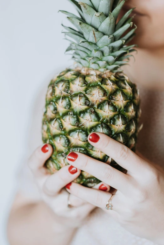 a woman holding a pineapple in her hands, subtle detailing, uncrop, highly polished, mix