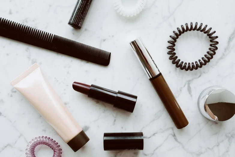 various beauty products laid out on a marble surface, trending on pexels, hurufiyya, long lashes, brown, monochromatic, lipstick