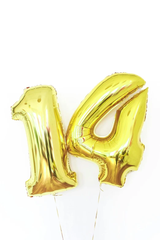 gold foil balloons in the shape of the number 14, a picture, by Nicolette Macnamara, pexels, high key, 👰 🏇 ❌ 🍃, rated t for teen, yellowed with age